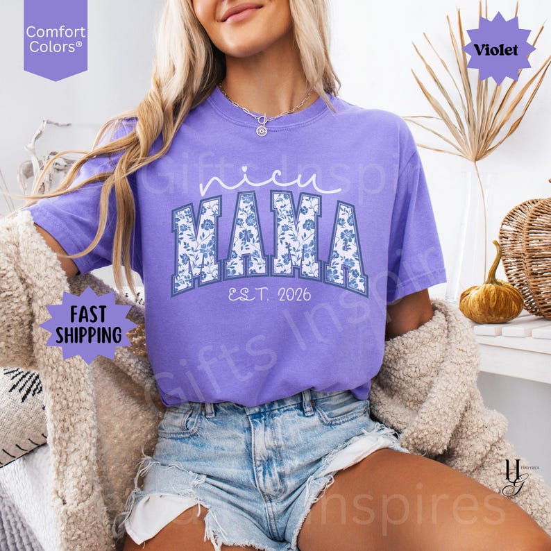 May include: A violet Comfort Colors t-shirt with the words "nicu MAMA EST. 2026" in white and blue floral print. The shirt is short-sleeved and worn with denim shorts. The words "Fast Shipping" are also visible.