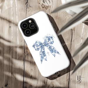 May include: White phone case with a blue and white floral bow and the text "Love Like Jesus".