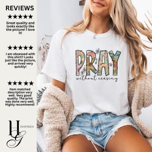 May include: White t-shirt with the word "PRAY" in colorful floral letters and the phrase "without ceasing" in black script. The shirt is worn with denim shorts and a beige cardigan.