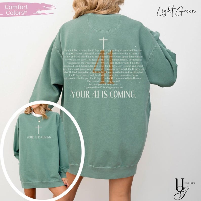 May include: A light green crewneck sweatshirt featuring a white cross and text on the back detailing biblical events related to the number 40, ending with the phrase YOUR 41 IS COMING. A smaller circular inset shows the front of the same sweatshirt.