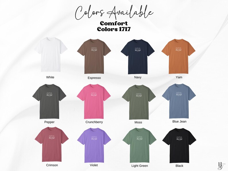 May include: A color chart displaying twelve Comfort Colors 1717 t-shirts in white, espresso, navy, yam, pepper, crunchberry, moss, blue jean, crimson, violet, light green, and black. Each shirt features small white text centered on the chest.
