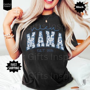 May include: Black t-shirt with the word "Mama" in a floral design, with "Est. 2026" below. The word "nicest" is above "Mama". The shirt is a Comfort Colors brand.