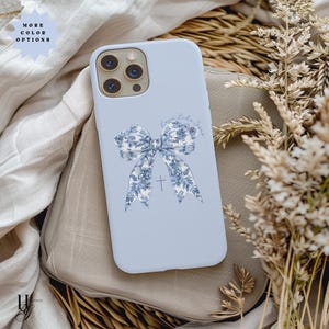 May include: A light blue phone case with a white and blue floral bow and a cross. The text "Love you like Jesus" is written on the case.