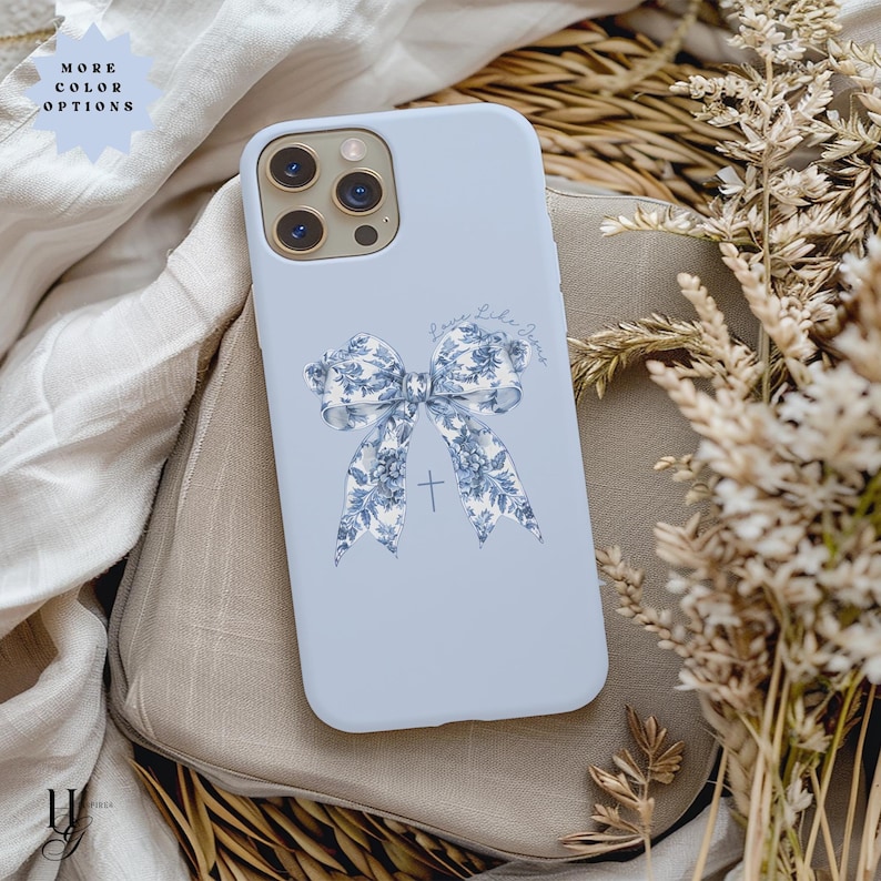 May include: A light blue phone case with a white and blue floral bow and a cross. The text "Love you like Jesus" is written on the case.