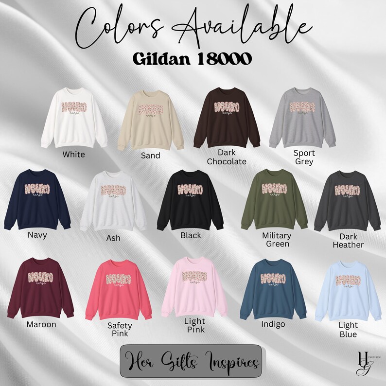 Puede incluir: Una selecci&oacute;n de sudaderas Gildan 18000 en varios colores, incluyendo blanco, arena, chocolate oscuro, gris deportivo, azul marino, ceniza, negro, verde militar, gris oscuro, granate, rosa de seguridad, rosa claro, &iacute;ndigo y azul claro. Cada sudadera presenta la palabra "NOUKO" en un dise&ntilde;o floral.