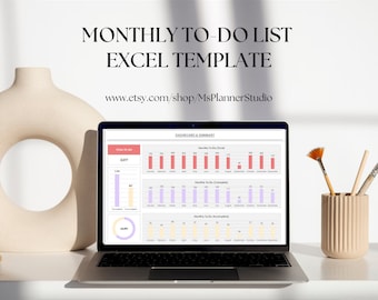 May include: A laptop computer displaying a monthly to-do list Excel template with charts and graphs. The template includes a dashboard and summary section with data on completed and incomplete tasks. The laptop is on a white desk with a vase of paintbrushes.