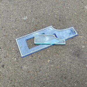 May include: Three clear acrylic quilting rulers with blue edges are displayed on a gray surface. The rulers include a rectangular shape with a cut-out, a curved shape, and a smaller rectangular ruler. Measurements are in inches.
