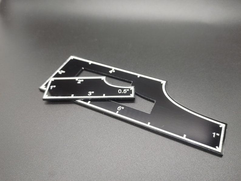 May include: Black acrylic quilting templates with white markings. The templates include measurements in inches, such as 1", 2", 3", 0.5", and 6". These tools are designed for precise cutting and marking in quilting projects.