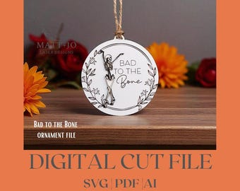 May include: A white circular ornament with a skeleton design and the text "Bad to the Bone." The ornament is hanging by a natural twine string. The words "Digital Cut File" and "SVG PDF AI" are also visible.