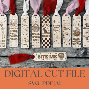 May include: Wooden Halloween-themed bookmarks with various designs, including ghosts, pumpkins, and skeletons, each with a colorful ribbon. The bookmarks feature phrases like "Bad to the Bone" and "Let's Go Ghouls". A separate bookmark reads "Bite Me".