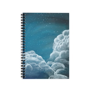 May include: Spiral-bound notebook with a painting of a night sky, featuring fluffy white clouds and scattered stars against a deep blue backdrop. The notebook has a black spiral binding.