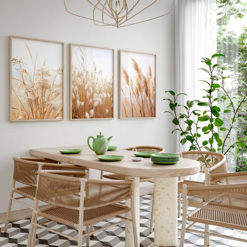 Dry Pampas Grass Neutral Wall Art Set of 3 in a bright cozy boho kitchen with wooden table and rattan chairs