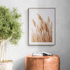 Dry Pampas Grass Neutral Wall Art Set of 3 over a leather pouf and floor plant