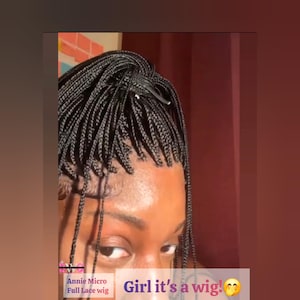May include: Close-up of a person's face with a micro braid wig. The wig is black and styled in small, neat braids. Text on the image reads "Girl it's a wig!" and "Annie Micro Full Lace wig."