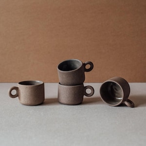 Set of handmade terracotta coffee cups with matte finish and minimalist design