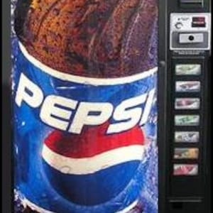 May include: A black vending machine with a large Pepsi advertisement. The ad features a bottle of Pepsi with the brand's logo in white and red against a blue background. The machine has selection buttons and a coin slot.