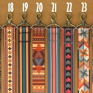 May include: Ten different patterned straps with gold metal clasps. The straps are numbered 17 through 24.