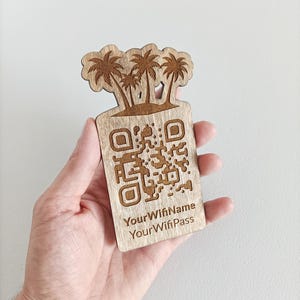 May include: Wooden sign with a palm tree design and a QR code. The sign also includes the text "Your Wifi Name" and "Your Wifi Pass".