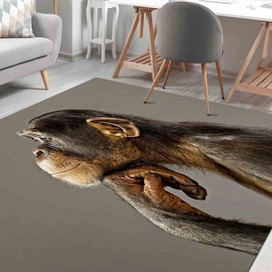 May include: A gray area rug with a close-up image of a brown chimpanzee with its arm resting on its head.