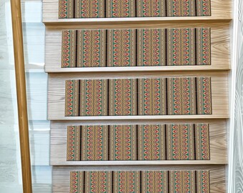 May include: Stair treads with a geometric pattern in shades of tan, red, green, and black. The treads are installed on wooden stairs. The pattern is a repeating vertical design with a tribal aesthetic.
