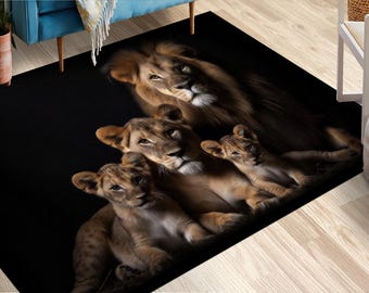 May include: A black rectangular rug with a lion family design. The image shows a male lion, a lioness, and two cubs. The lions are in shades of brown and tan, with detailed fur textures. The rug is suitable for a living room or bedroom.