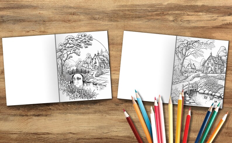 Puede incluir: Un libro de colorear abierto con dos ilustraciones en blanco y negro de una escena campestre con un puente, un r&iacute;o y casas. El libro est&aacute; sobre una superficie de madera con l&aacute;pices de colores.