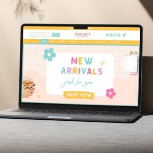 May include: A laptop computer displaying a website with a pink, yellow, and blue color scheme. The website features the text "Soulmate & Co." and "New Arrivals just for you." with a button that says "Shop Now".