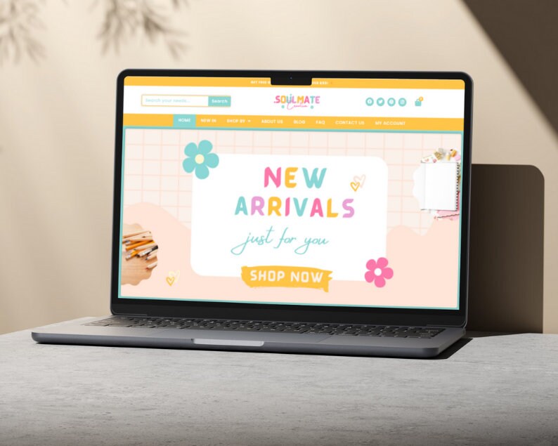 May include: A laptop computer displaying a website with a pink, yellow, and blue color scheme. The website features the text "Soulmate & Co." and "New Arrivals just for you." with a button that says "Shop Now".