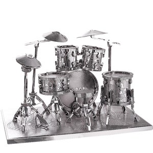 May include: A silver metal model of a drum kit with four drums, two cymbals, and a drum stool. The drums have a textured surface and the cymbals are flat and round.