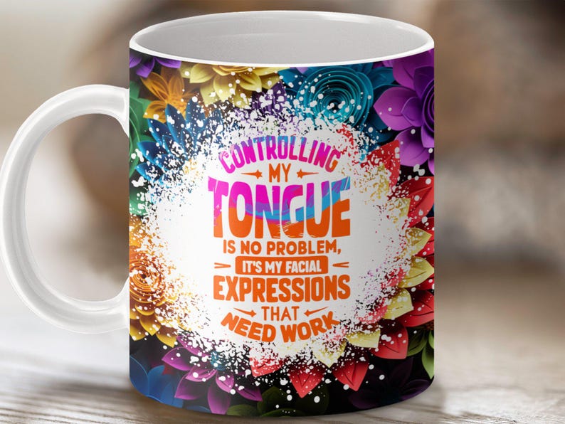 May include: White ceramic mug with a colorful floral design. The mug features the text "CONTROLLING MY TONGUE IS NO PROBLEM, IT'S MY FACIAL EXPRESSIONS THAT NEED WORK".