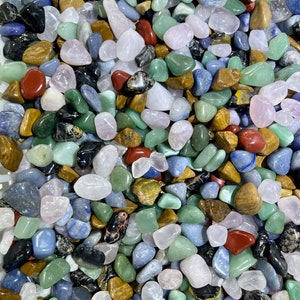 May include: A collection of tumbled stones in various colors, including green, blue, pink, brown, and red. The stones are smooth and polished, and they are perfect for use in crafts, jewelry making, or as decorative accents.