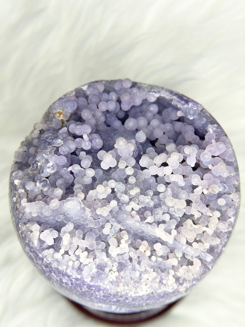 Massive Indonesian grape agate orb. Vivid purple crystal sphere with raw druzy pocket. Spiritual growth aid, energy amplifier. Rare mineral specimen for collectors and enthusiasts.