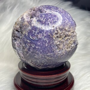XL purple grape agate crystal ball, Indonesia origin. Raw druzy pocket, natural formation. Aids stress relief, chakra balancing. Stunning display piece for home or office decor.
