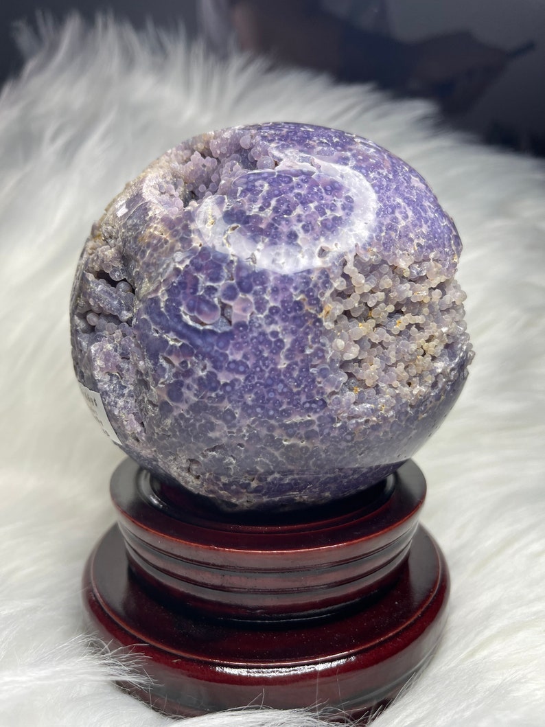 XL purple grape agate crystal ball, Indonesia origin. Raw druzy pocket, natural formation. Aids stress relief, chakra balancing. Stunning display piece for home or office decor.