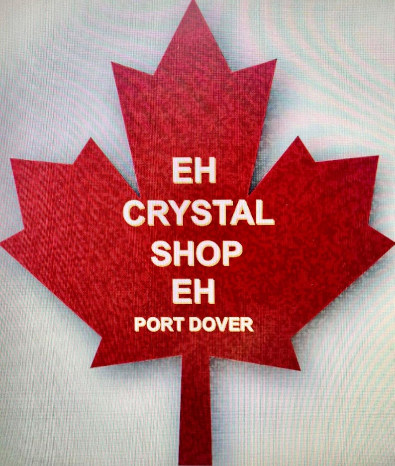 May include: A red maple leaf with the text "EH CRYSTAL SHOP EH PORT DOVER" in white.