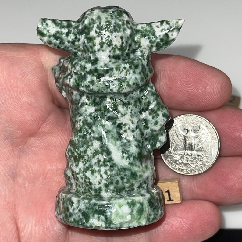 Crystal figurines: wise jadeite being and cute green jasper alien baby. Perfect for meditation, home decor, and gifting. Natural stone art with calming properties.