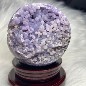 Huge purple grape agate sphere from Indonesia. Raw druzy pocket, metaphysical crystal ball. Natural formation, deep purple hue. Aids meditation, enhances intuition, promotes calm. Unique collector's item.