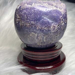 Jumbo grape agate sphere, Indonesian source. Deep purple crystal with druzy pocket. Enhances psychic abilities, promotes emotional healing. Unique metaphysical tool and conversation starter.