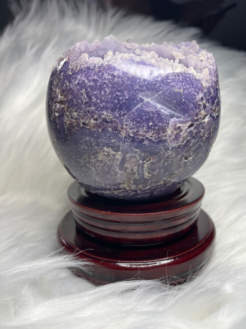 Jumbo grape agate sphere, Indonesian source. Deep purple crystal with druzy pocket. Enhances psychic abilities, promotes emotional healing. Unique metaphysical tool and conversation starter.
