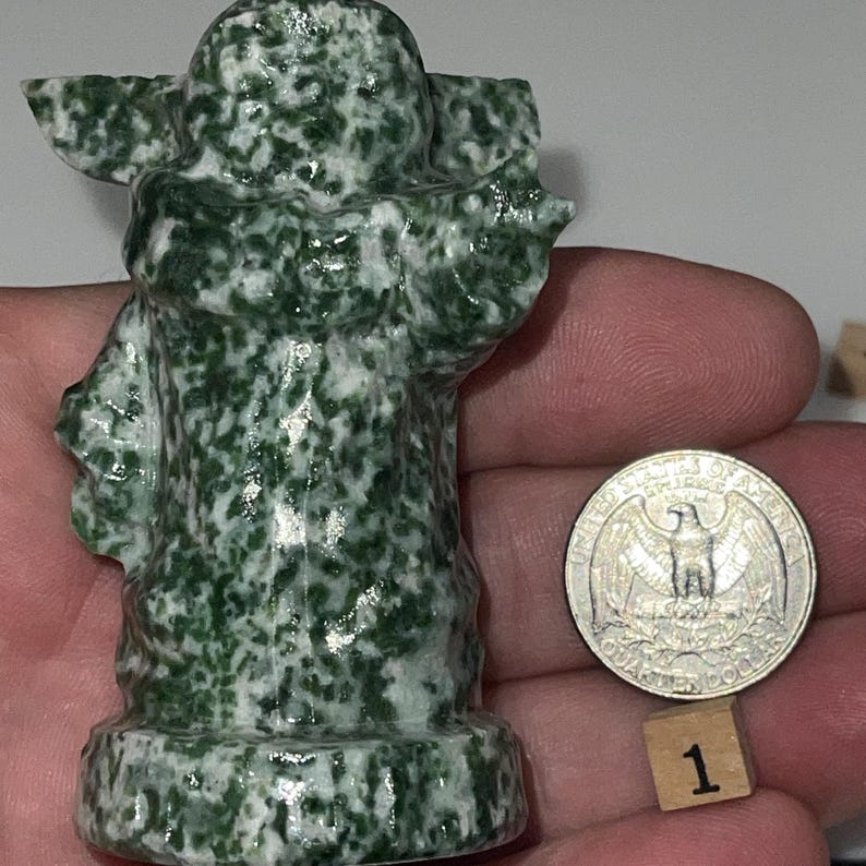 Hand-carved jadeite master and green dot jasper alien infant sculptures. Charming desk accessories, metaphysical tools, and unique conversation pieces.