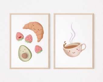 May include: Two framed prints with illustrations of food. The left print features a croissant, avocado, and strawberries with happy faces. The right print features a cup of coffee with a happy face and steam rising from it.