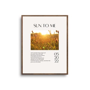May include: A printable wall art print with a sunset photo of a field of wildflowers and the text "SUN TO ME" and the date "05 20 22".