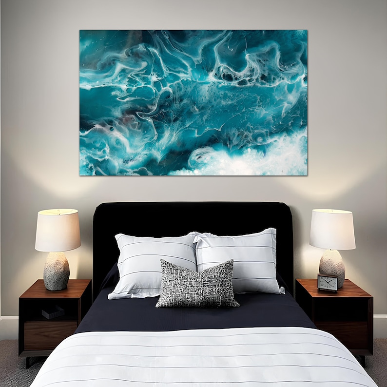 Puede incluir: Un interior de dormitorio con una cama, dos mesitas de noche y l&aacute;mparas. Sobre la cama hay una gran pintura abstracta con patrones azules y blancos que se arremolinan.