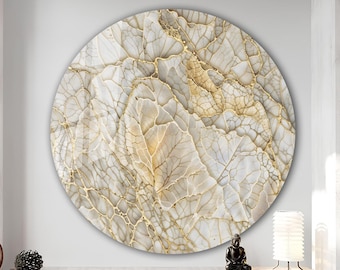 May include: A circular wall art piece with an abstract design in cream and gold. The artwork has a textured surface with vein-like patterns, creating a natural stone or leaf-like appearance. The piece is a decorative element for any room.