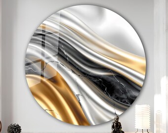 May include: Circular wall art with an abstract design in gold, silver, and black. The artwork has a flowing, wavy pattern, creating a sense of movement. It is mounted on a white wall.