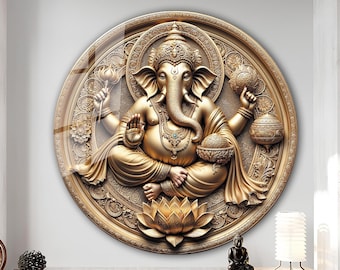 May include: A circular wall decoration featuring a golden, ornate sculpture of the Hindu deity Ganesha. The sculpture is set against a background of intricate floral designs and is surrounded by a circular frame.