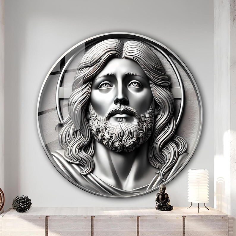 What Is 3D Laser Engraving May include: A round, silver-colored wall decor featuring a 3D relief sculpture of a man's face with long hair and a beard. The sculpture is set against a background of concentric circles.