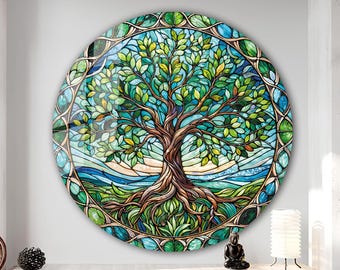 May include: A round stained glass wall art piece depicting a tree of life with green leaves, brown branches, and blue and green roots. The tree is surrounded by a decorative border of green, blue, and gold.