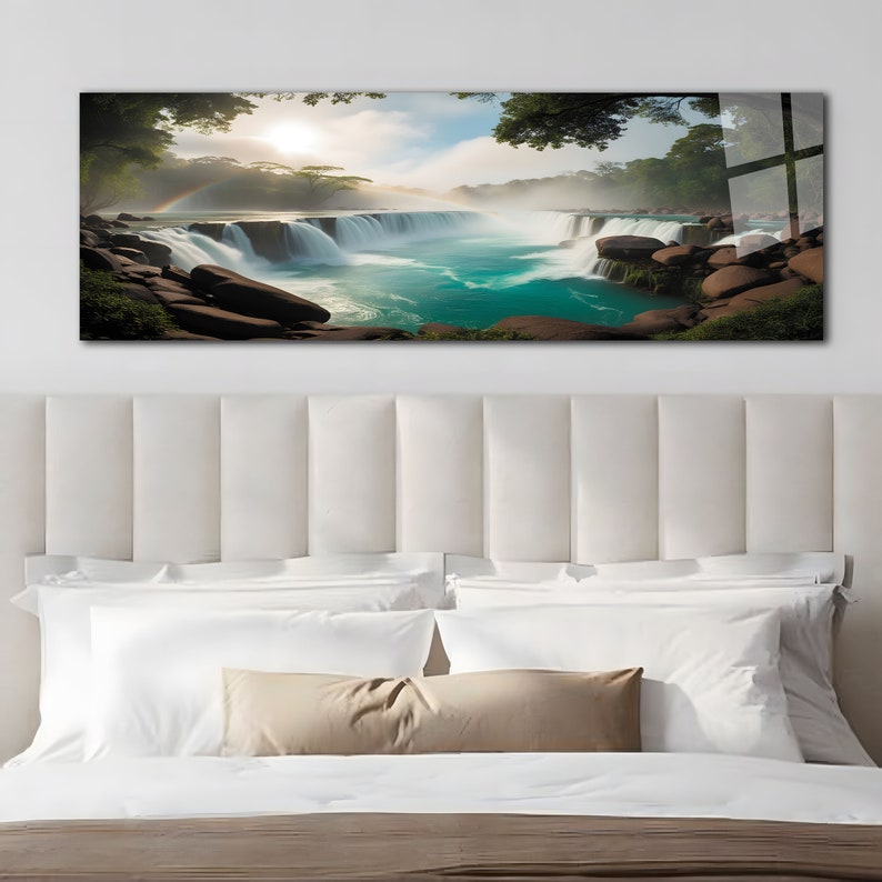 May include: A panoramic photograph of a waterfall cascading over rocks with a rainbow in the mist. Lush green trees frame the scene, and the water is a vibrant turquoise.