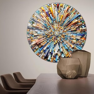 May include: A circular wall art piece with a colorful mosaic design. The mosaic is made up of small, geometric shapes in shades of blue, yellow, orange, and white. The design radiates outward from the center, creating a sense of movement and energy.